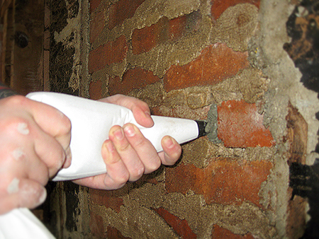 Tuckpoint and parge a chimney